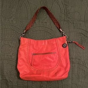 The Sak leather purse; orange/red color.